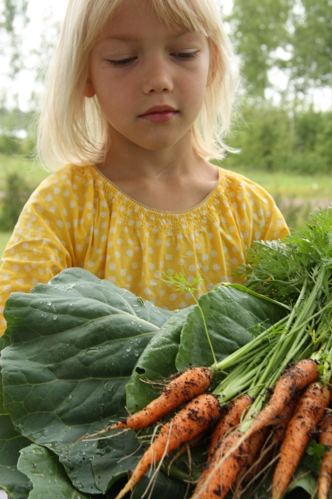 girl and organic garden produce